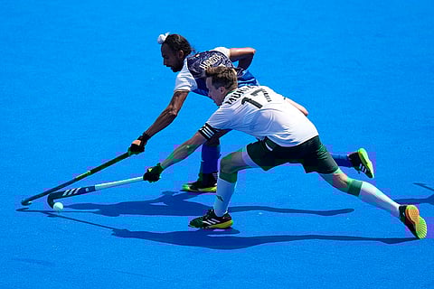 Sean Murray and Hardik Singh fight for the ball
